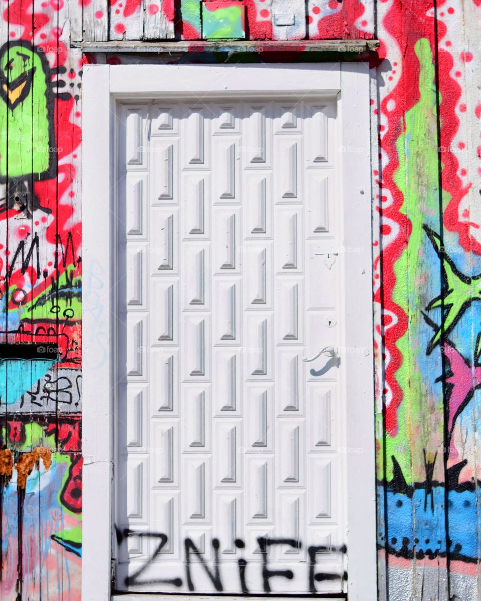 Door surrounded by grafitti