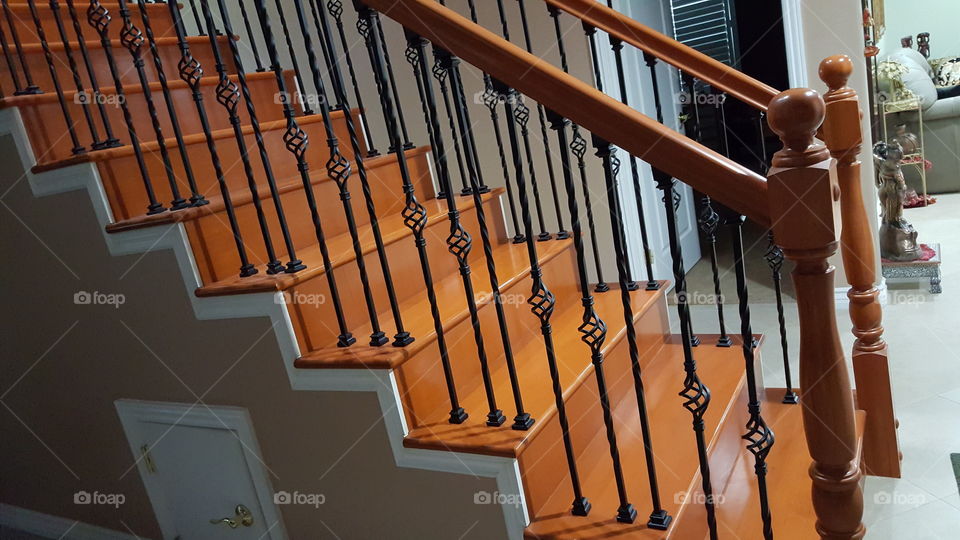 wooden stairs with metal railing
