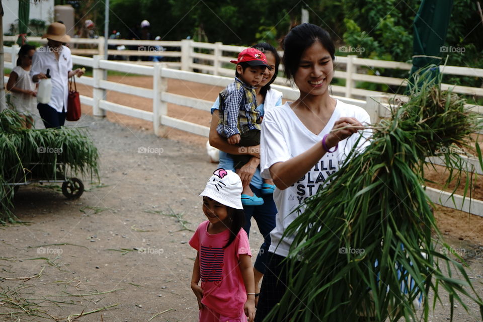 Family feeding farm animals