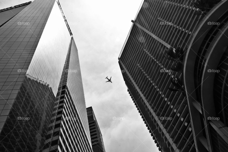 Black and white minimalist - Vertical architecture with a plane flying overhead  - 