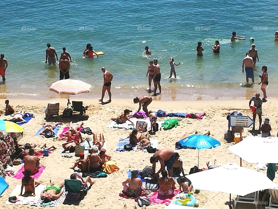 People by the sea in a beach.