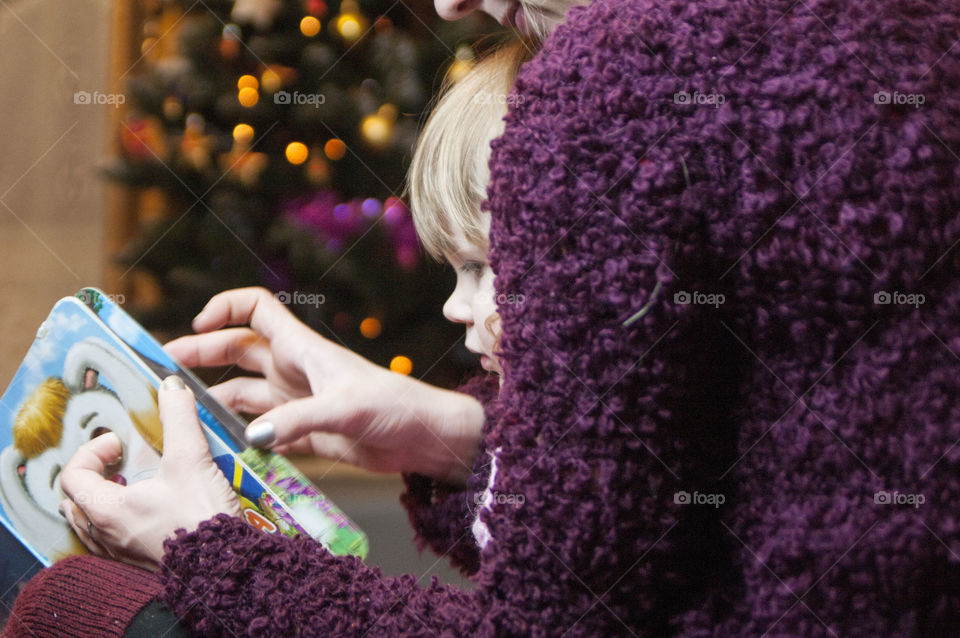 Mother little daughter reading book