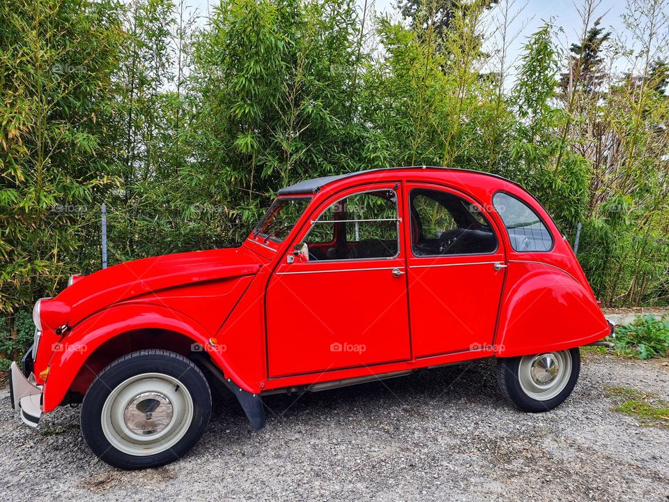 red vintage car parked on the street