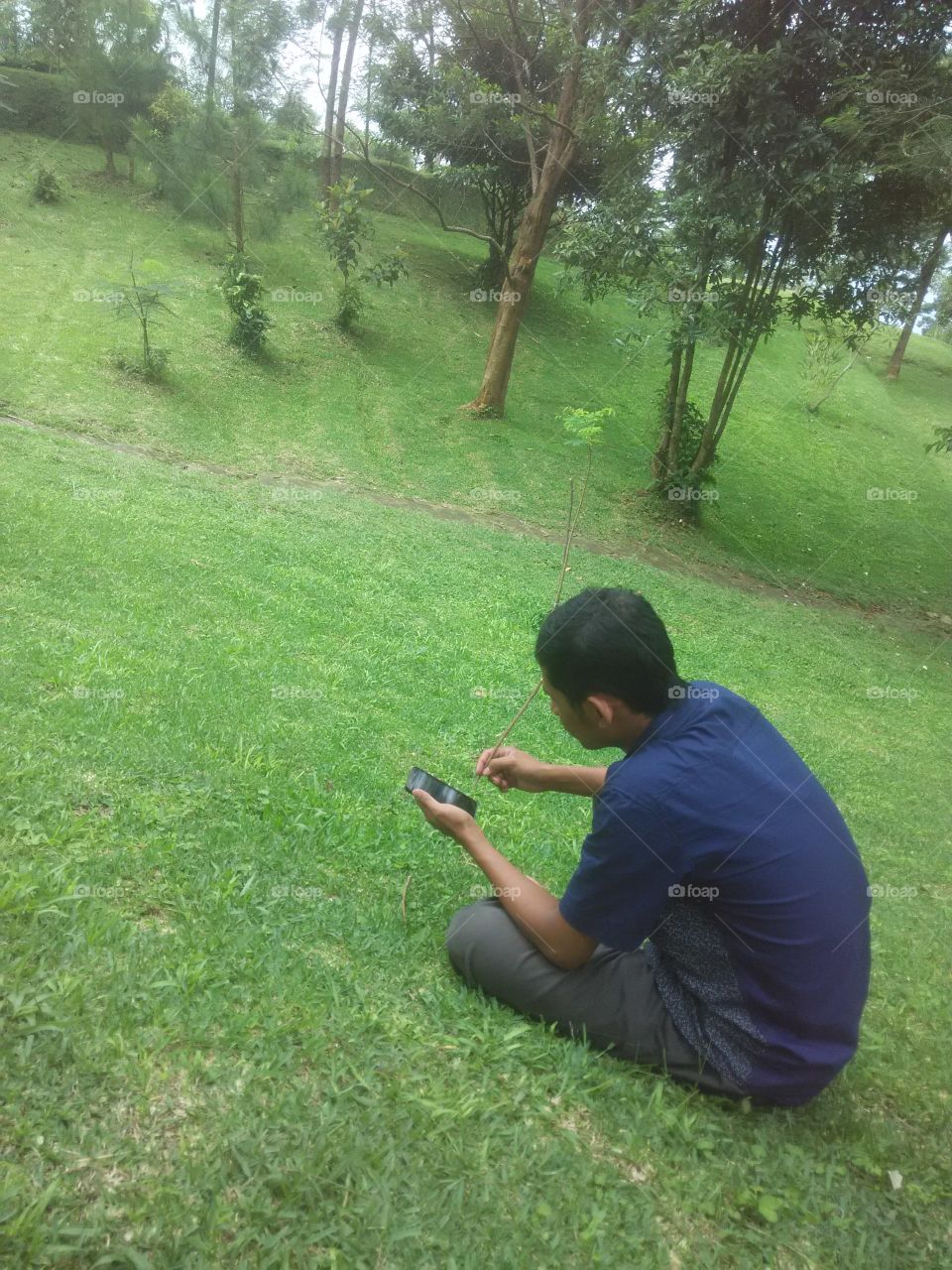 Playing Handphone arround grass