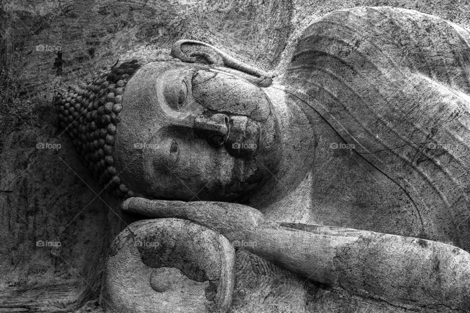Buddha statute  carved on natural rock at Thanthirimale, Sri Lanka. Black and white is the best. colour vs black and white.