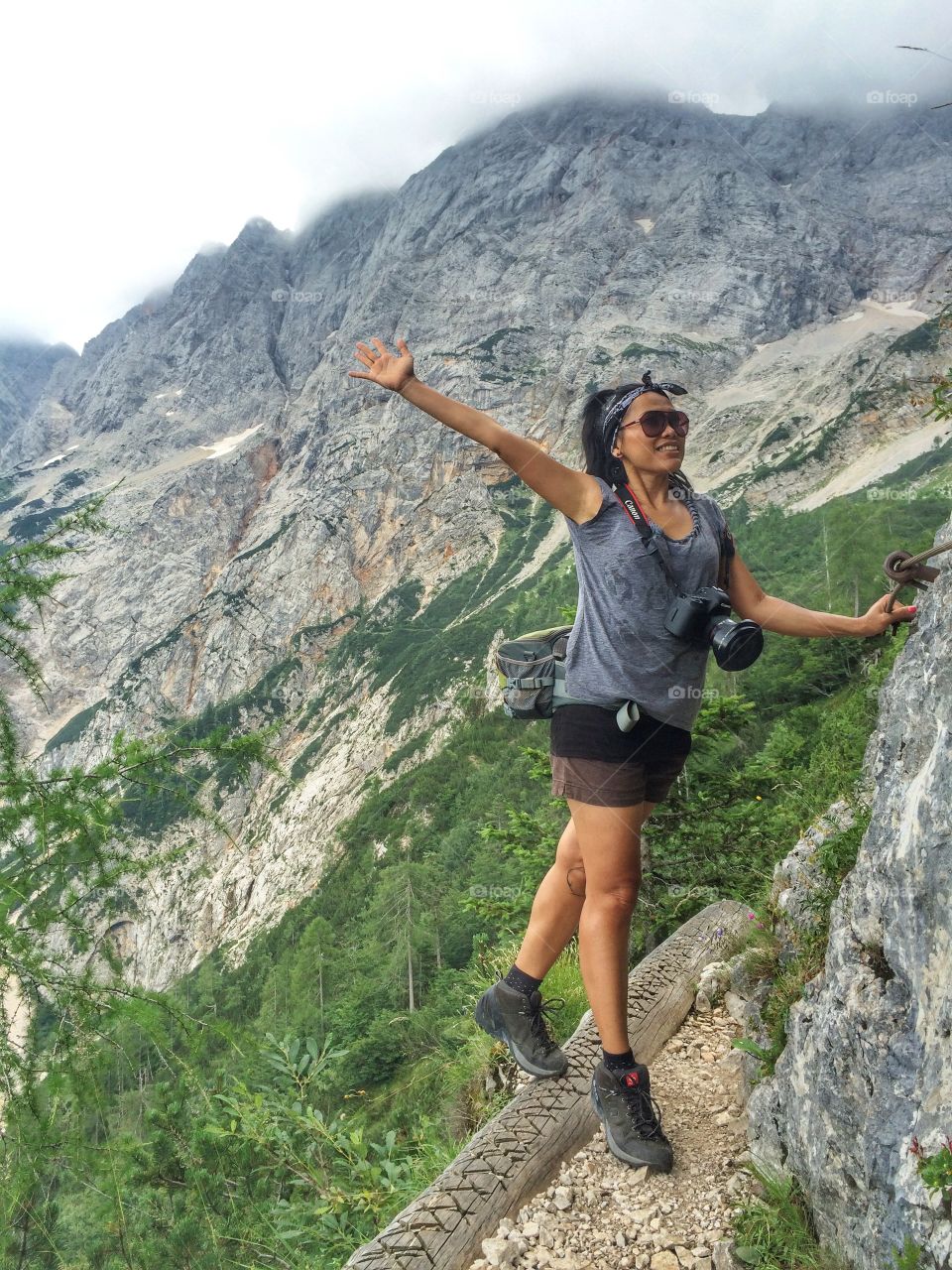 Young female hiker standing near mountain