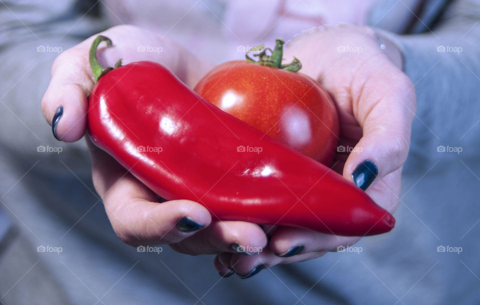 Mid section of girl holding vegetables