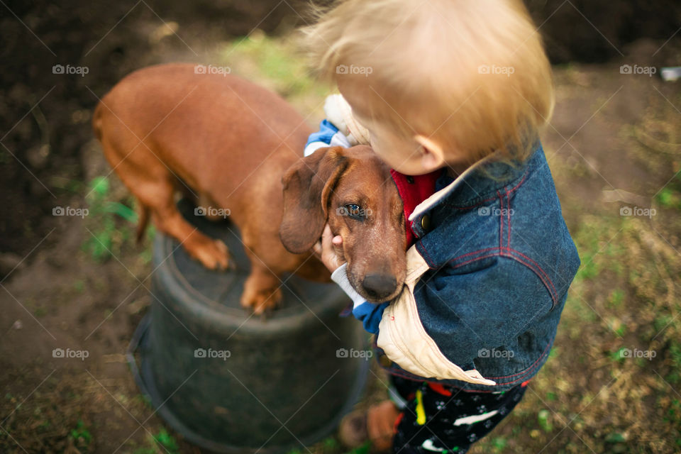High angle view of a child with puppy