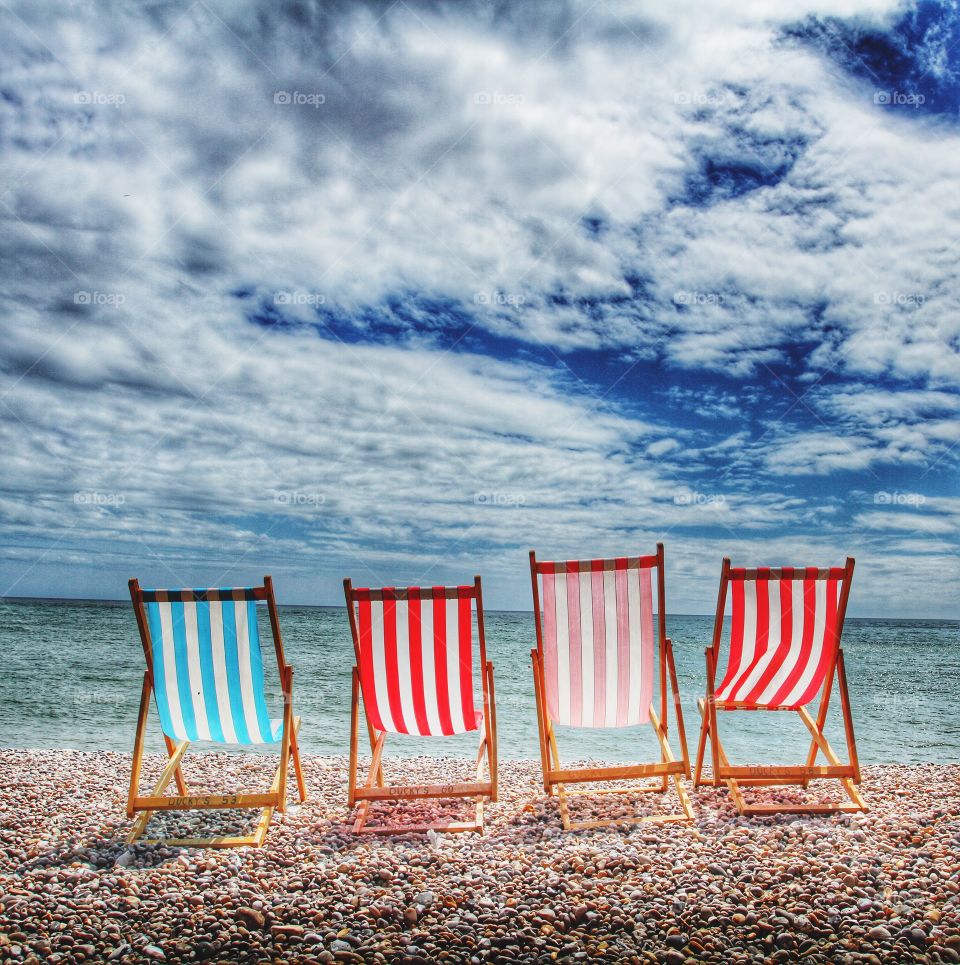 There is a pebble beach at a place called Beer in Devon that seems to catch the Suns rays from dawn till dusk. If you're on the beach early enough you might be able to get one of these traditional deckchairs which have an amazing sea view.