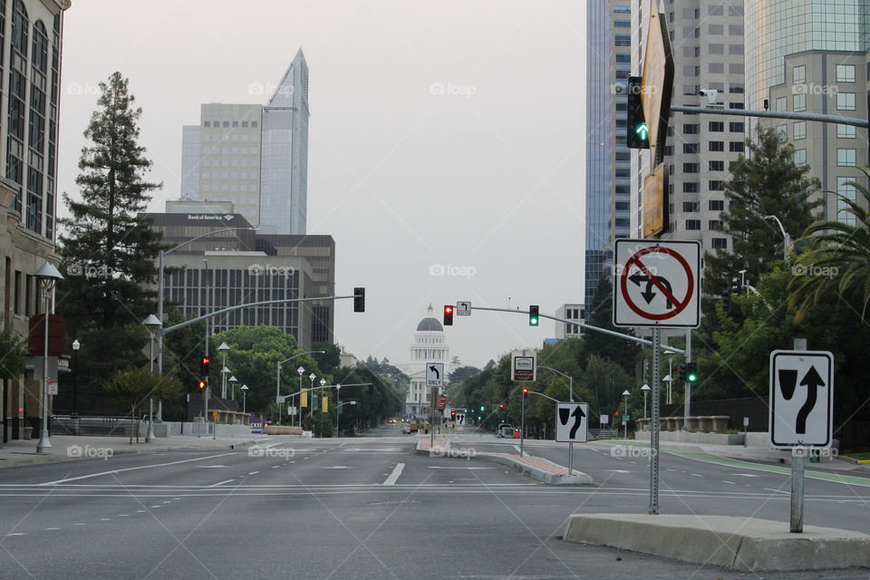 City Life, in the state's capital of Sacramento California. looking down Capitol avenue with the Capitol building in the far background.