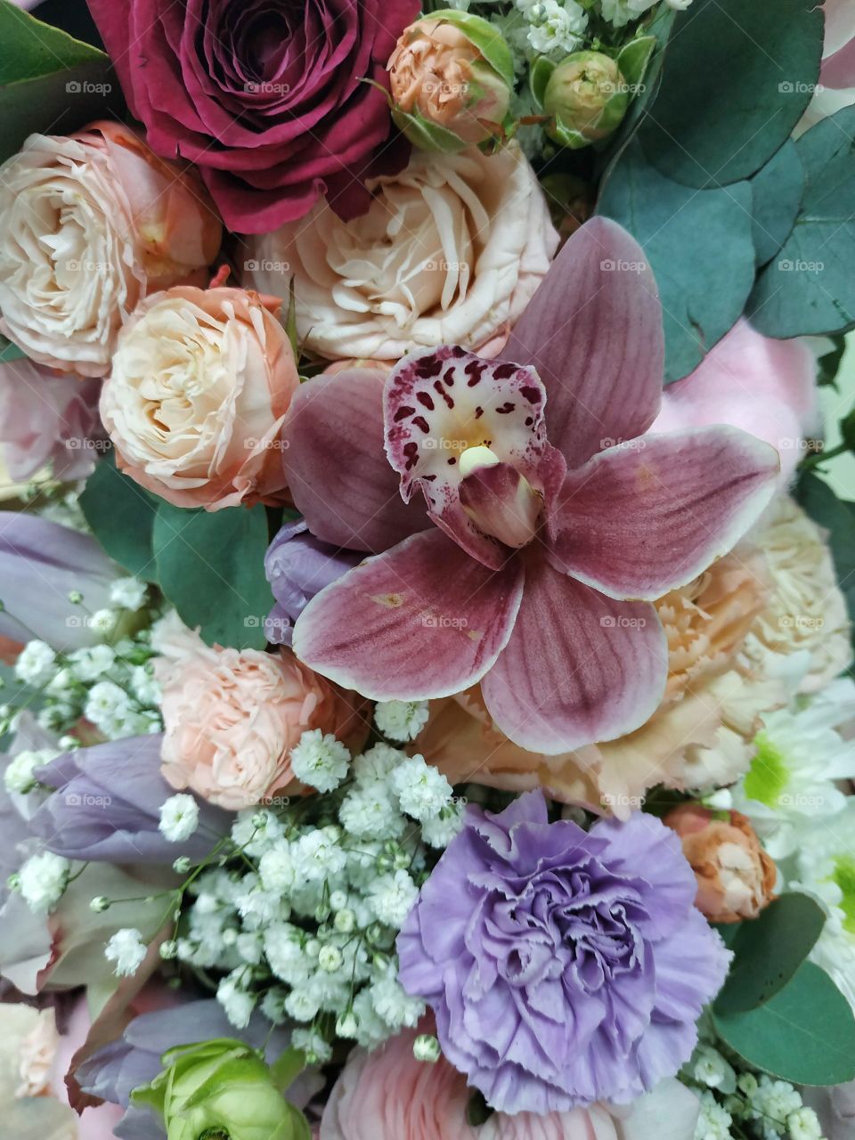 beautiful bucet of flowers with orchid, bush pose and delicate carnation