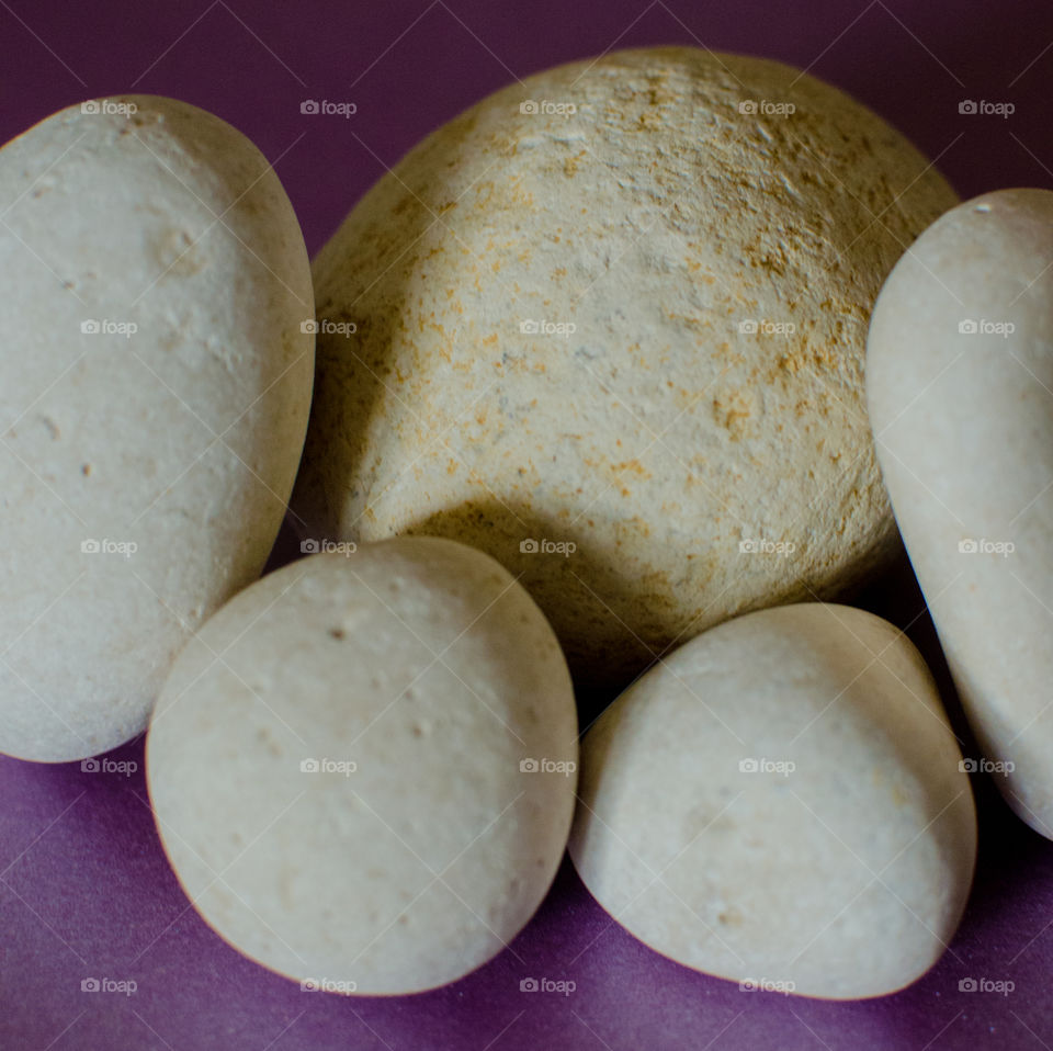 White rocks on purple background