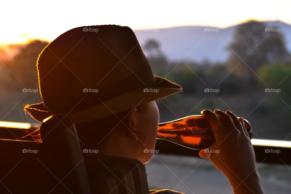 Enjoying drinks on the deck next to the river in the bush while watching the sunset.