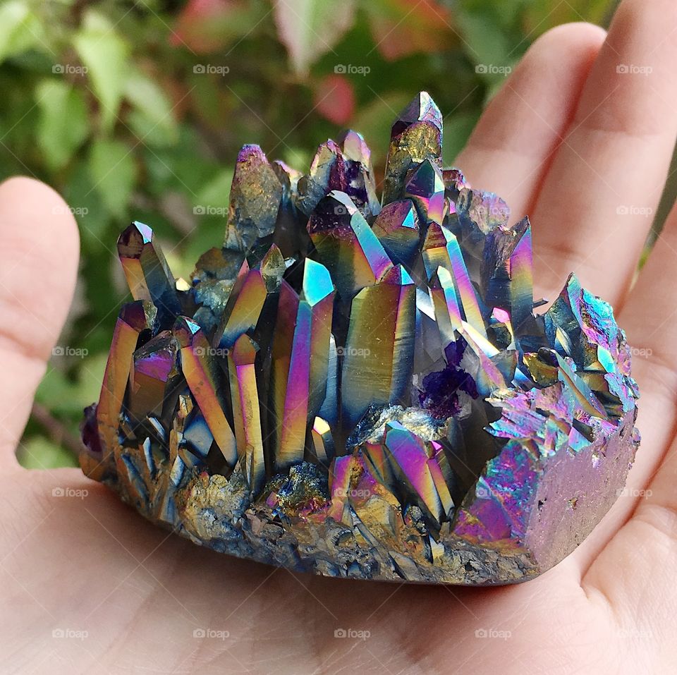 A rainbow aura quartz crystal cluster.