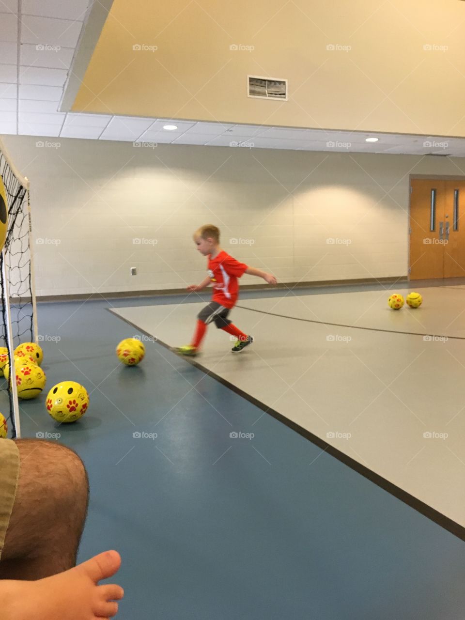 Small boy playing football