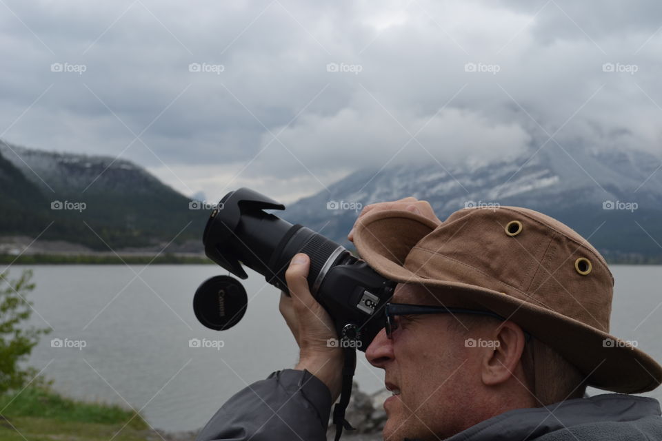 Close-up of man photographing with camera