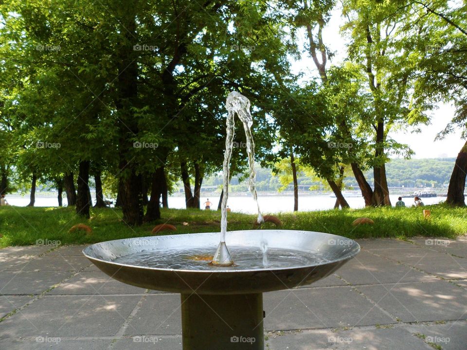 A stream of water is pouring from a drinking fountain