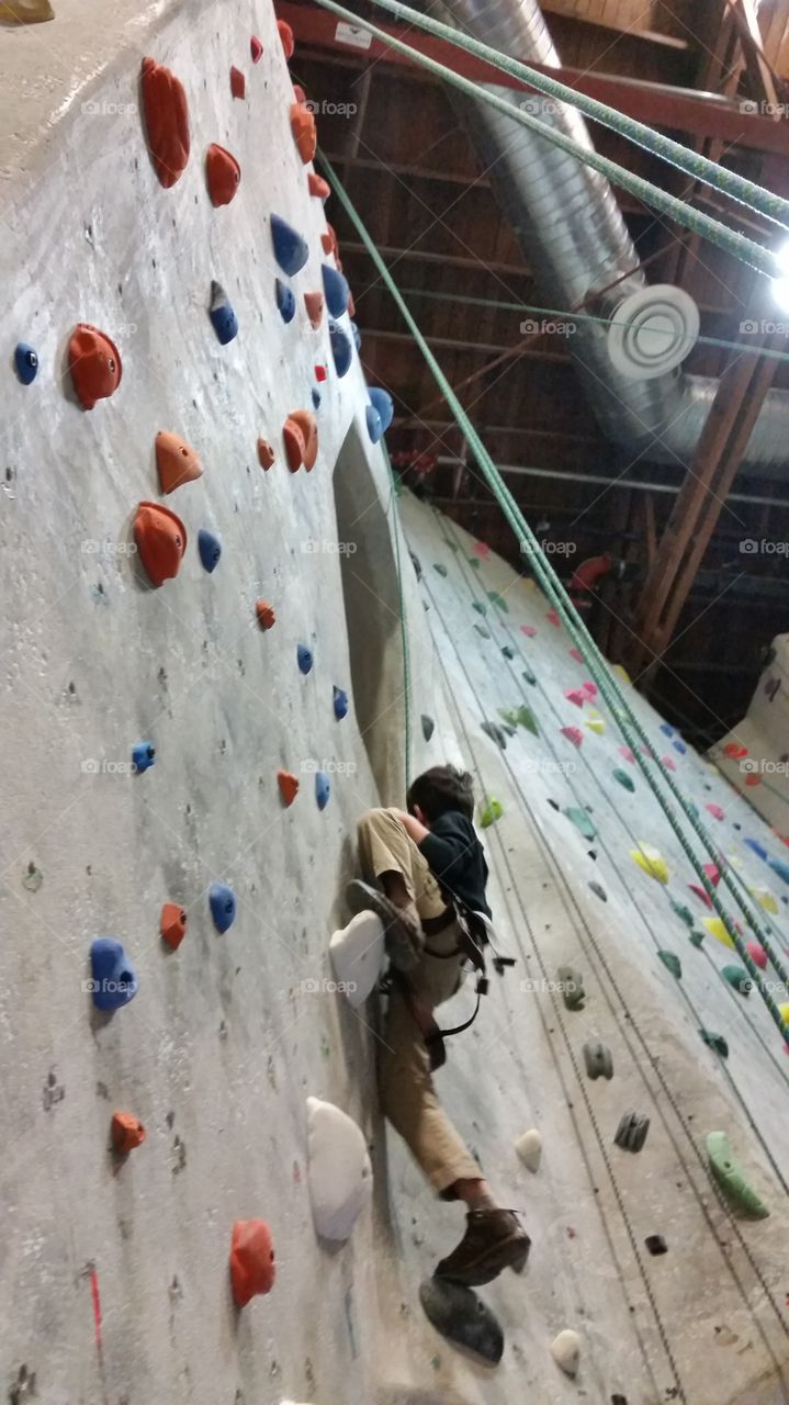 Boy doing indoor rock climbing