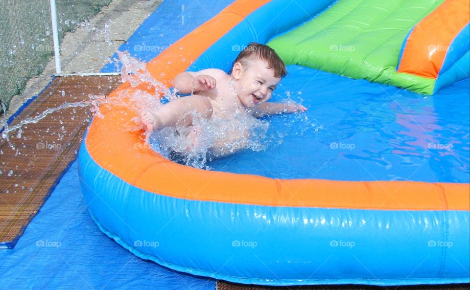 the child slides down the water slide