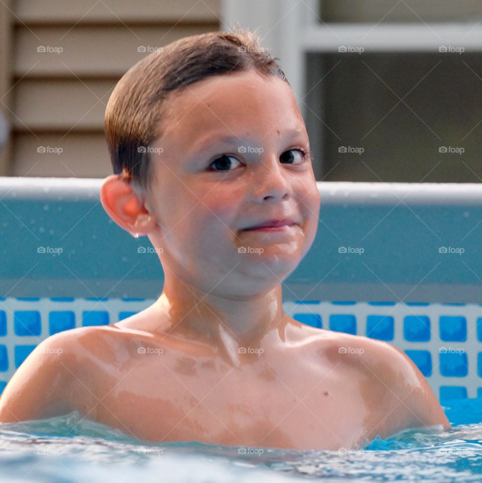 Boy smiling in pool