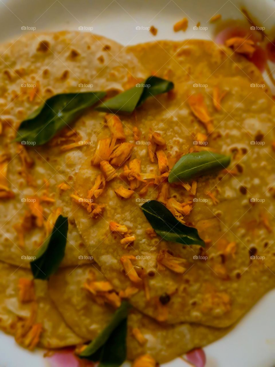 Chappathi garnished with chicken and curry leaves