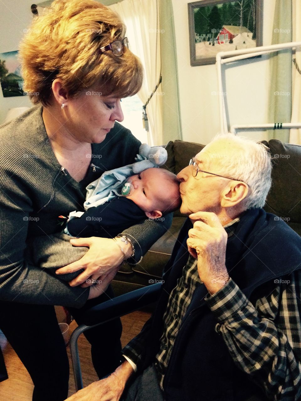 Grandfather kissing his grandchild