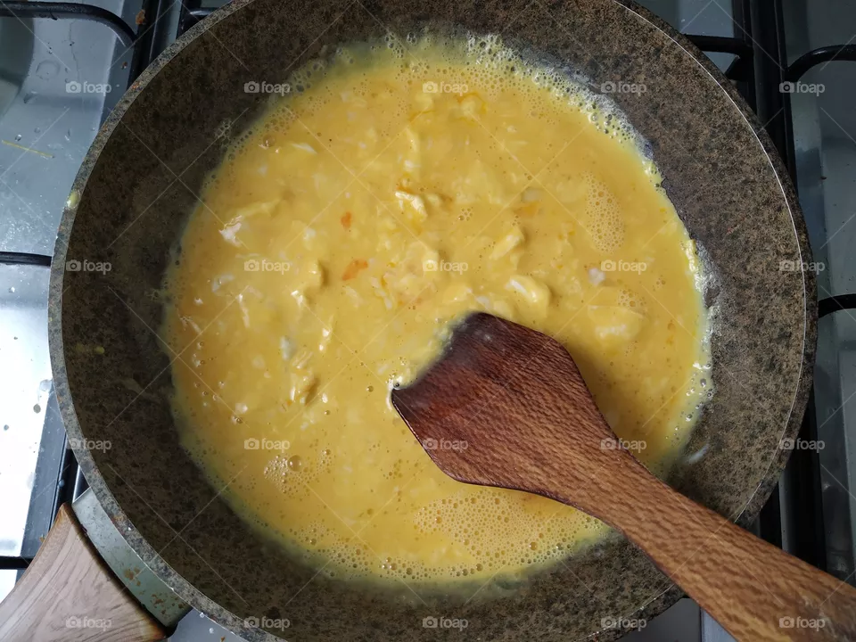 Scramble eggs in a fryingpan