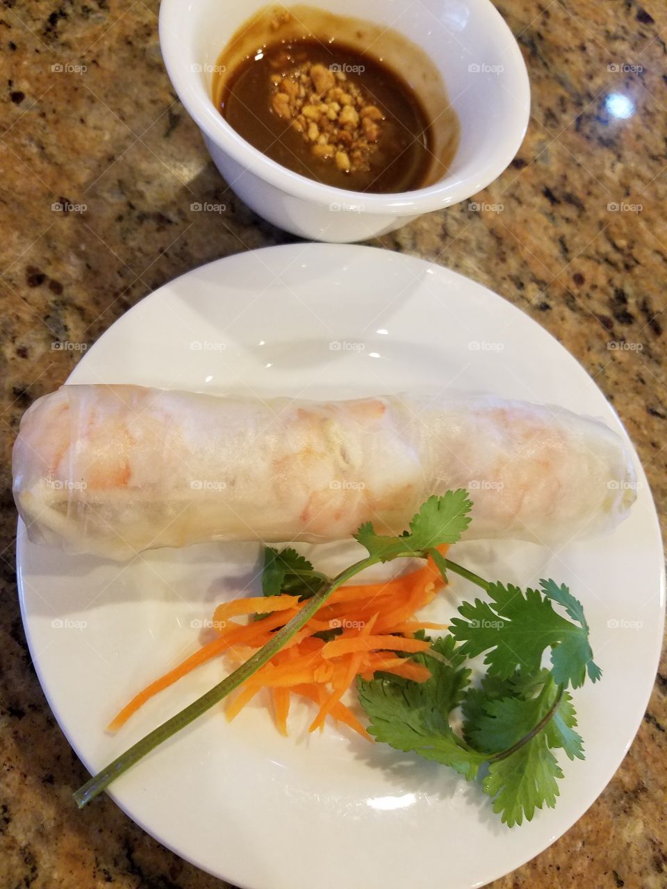 a spring roll with sauce