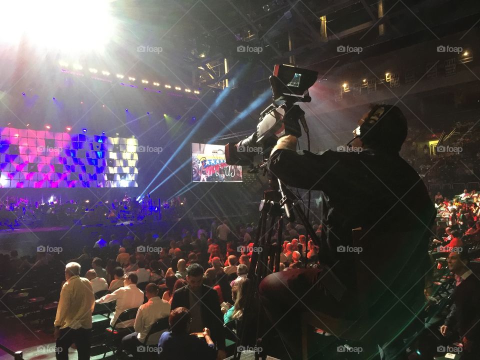 Show. Camera man operating video camera during a show