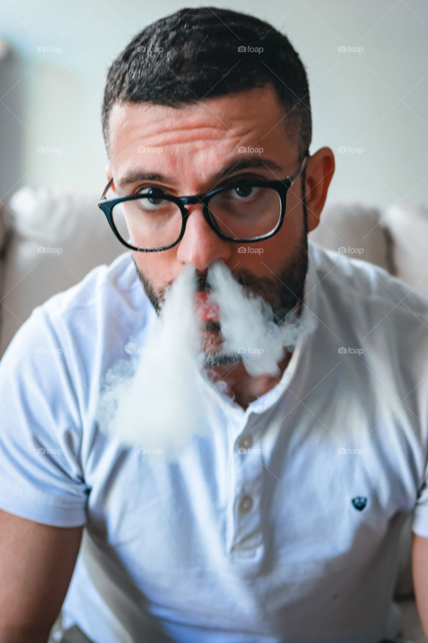 Man smoking while relaxed at home