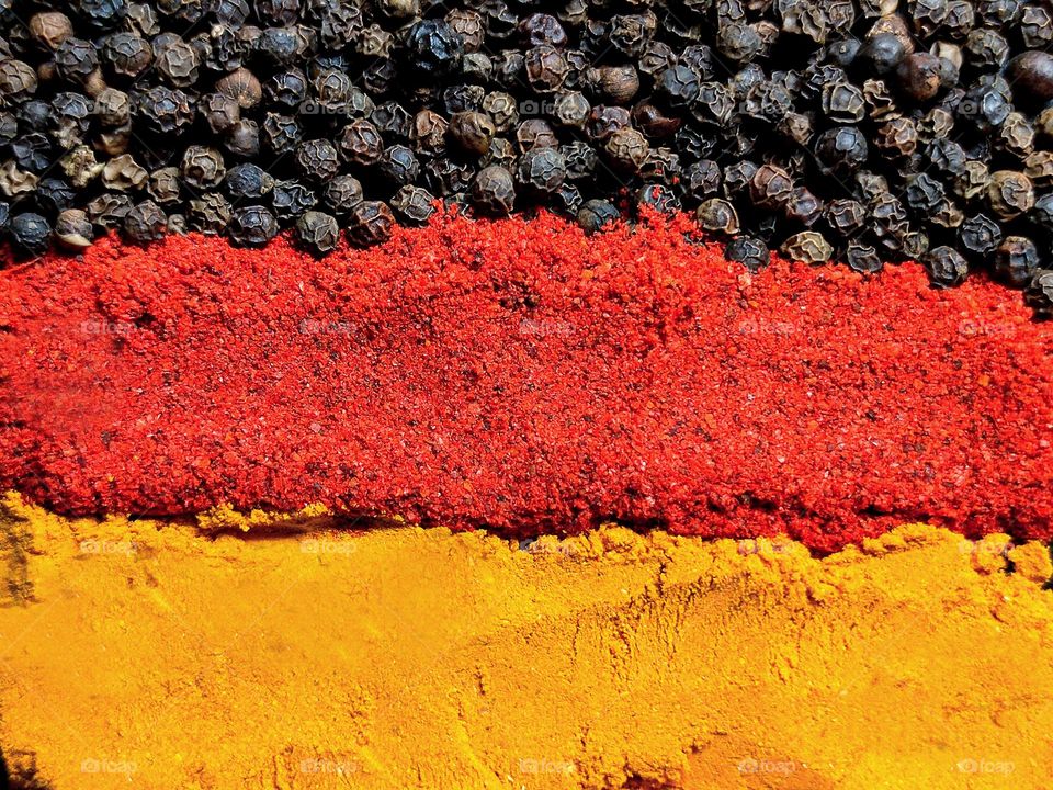 Flag of Germany from spices. A horizontal stripe of black peppercorns, a horizontal stripe of red paprika, and a horizontal stripe of golden turmeric.Black is a reminder of the years of reactions,red is the blood of patriots,gold is the color freedom