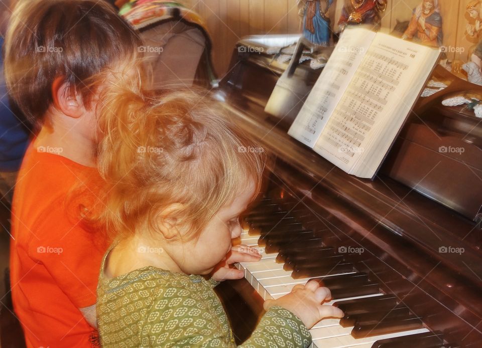 Young Children Playing Piano