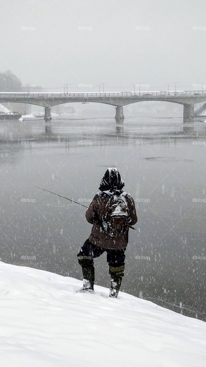 Snowfall and fisherman