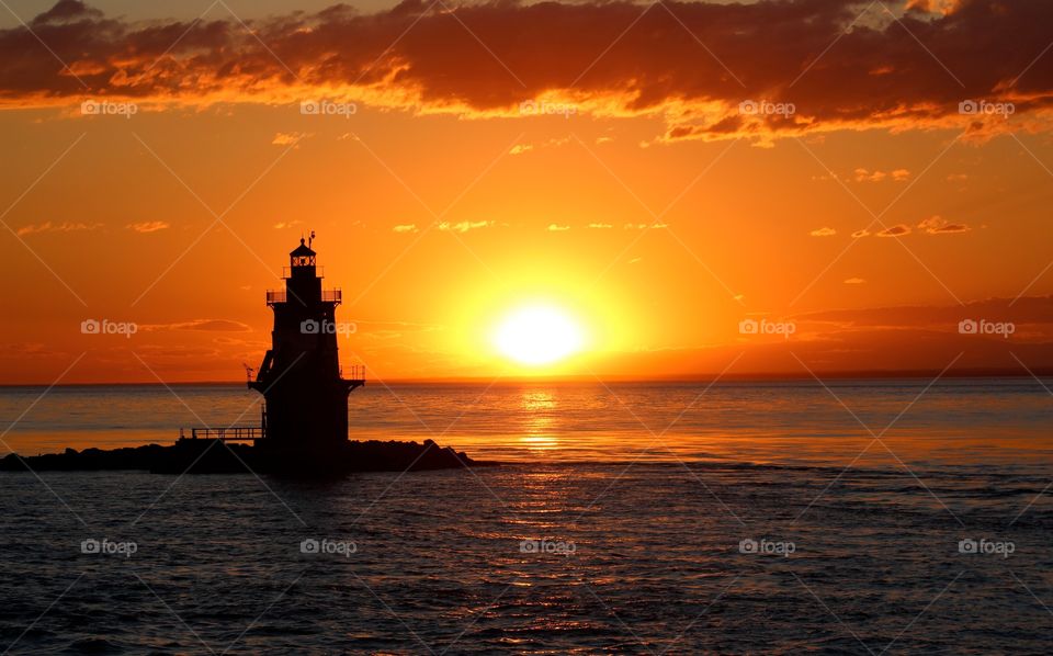 Golden sunset behind lighthouse 