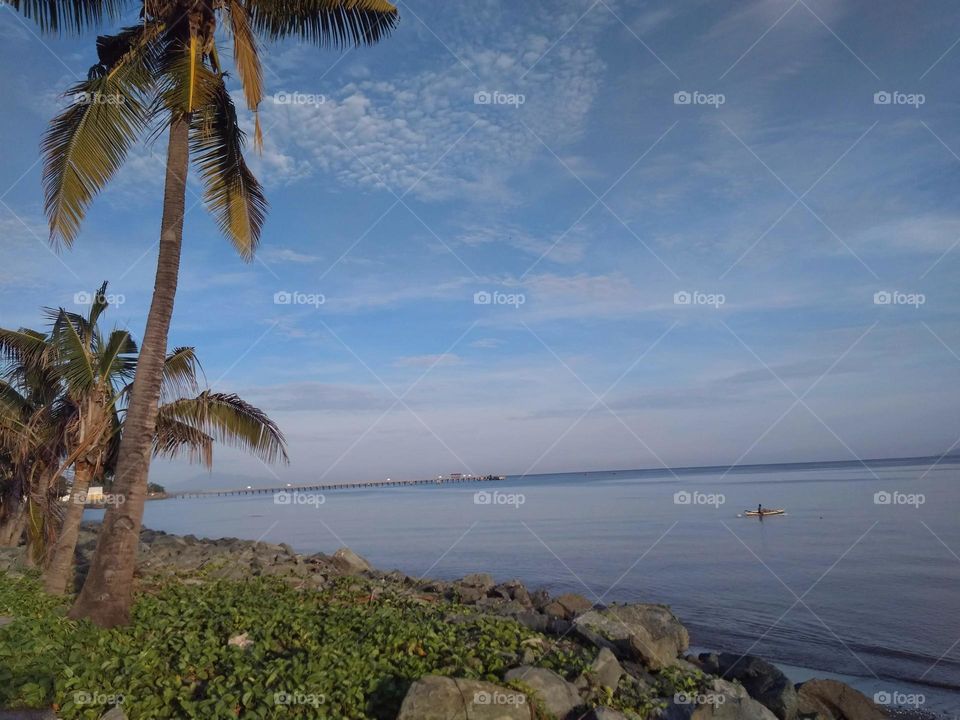 A solitary fisherman in a city beach