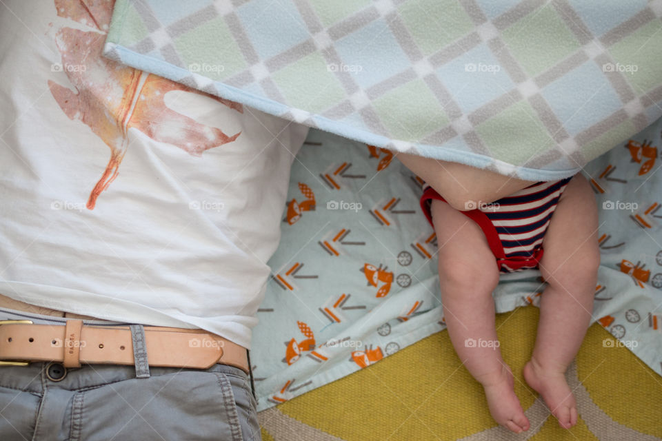 Father and son sleeping on the bed