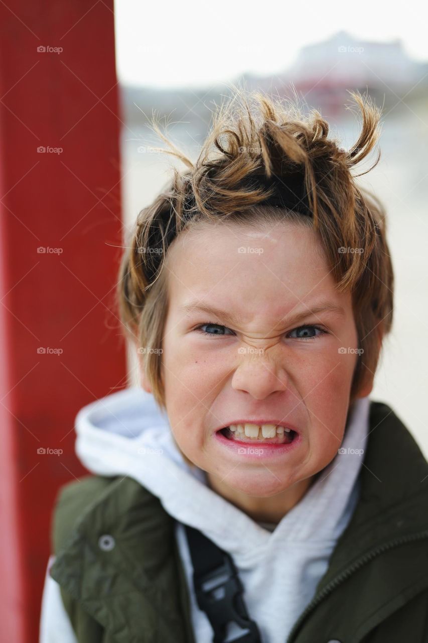 a boy of eight years old is experiencing the emotion of anger