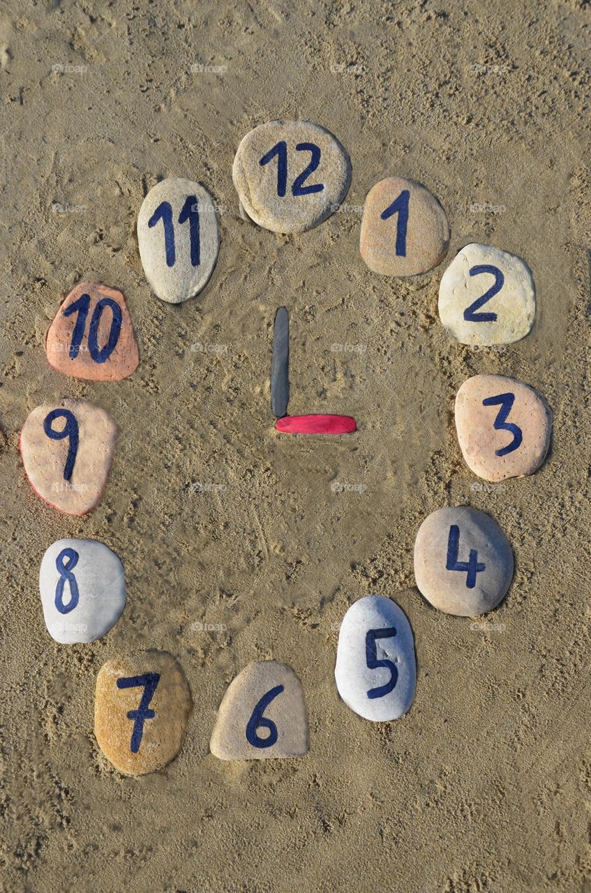 Stone watch on the sand