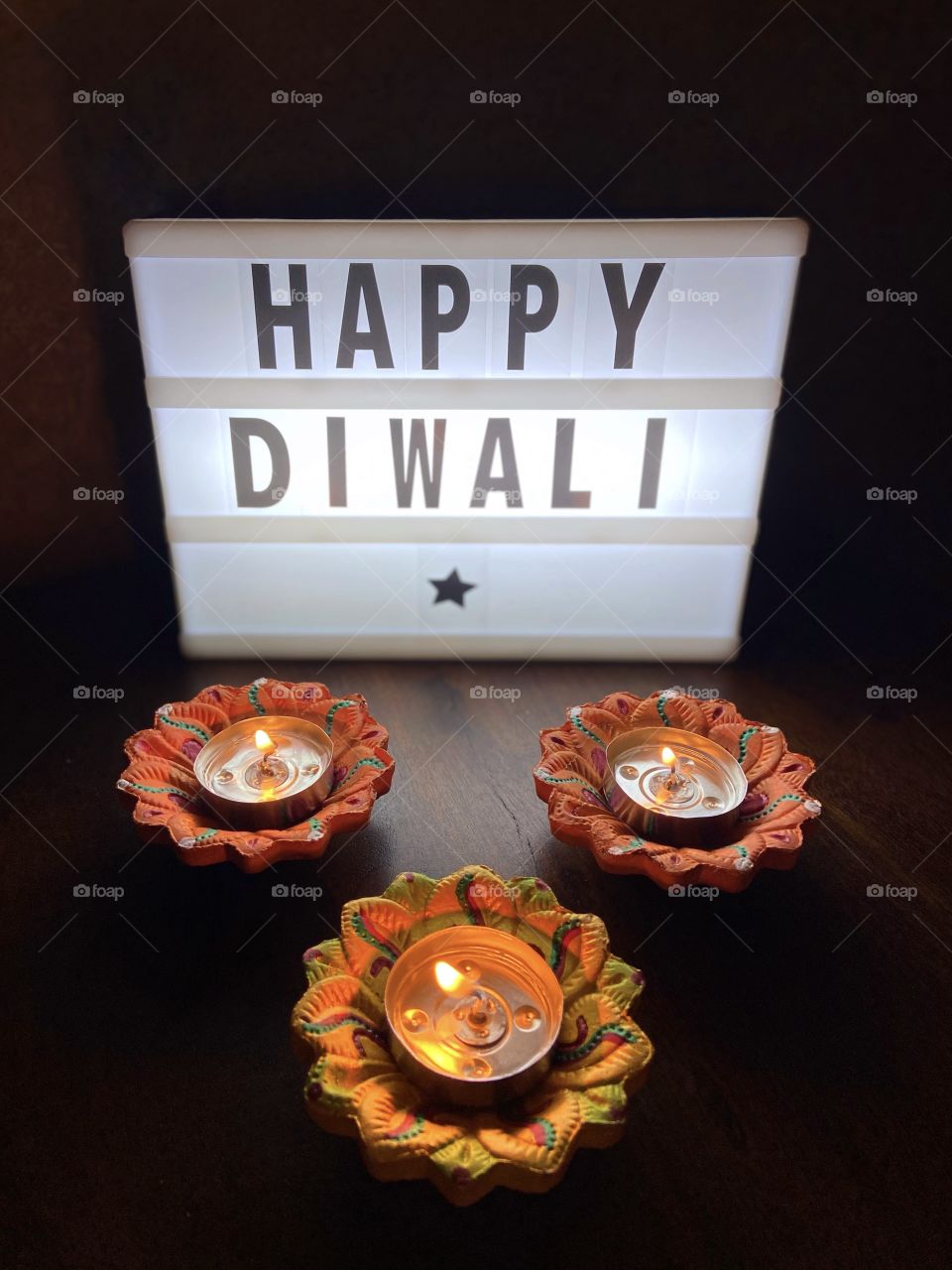 Happy Diwali with candles and light box 