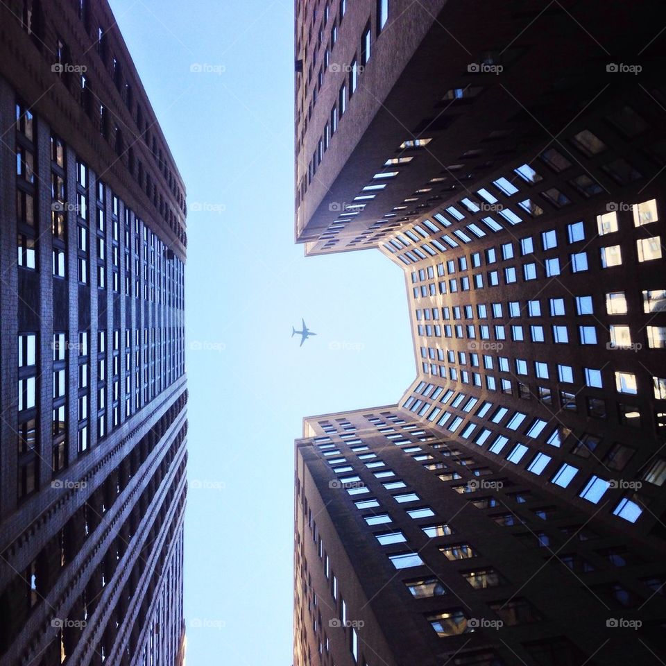 Airplane between buildings 