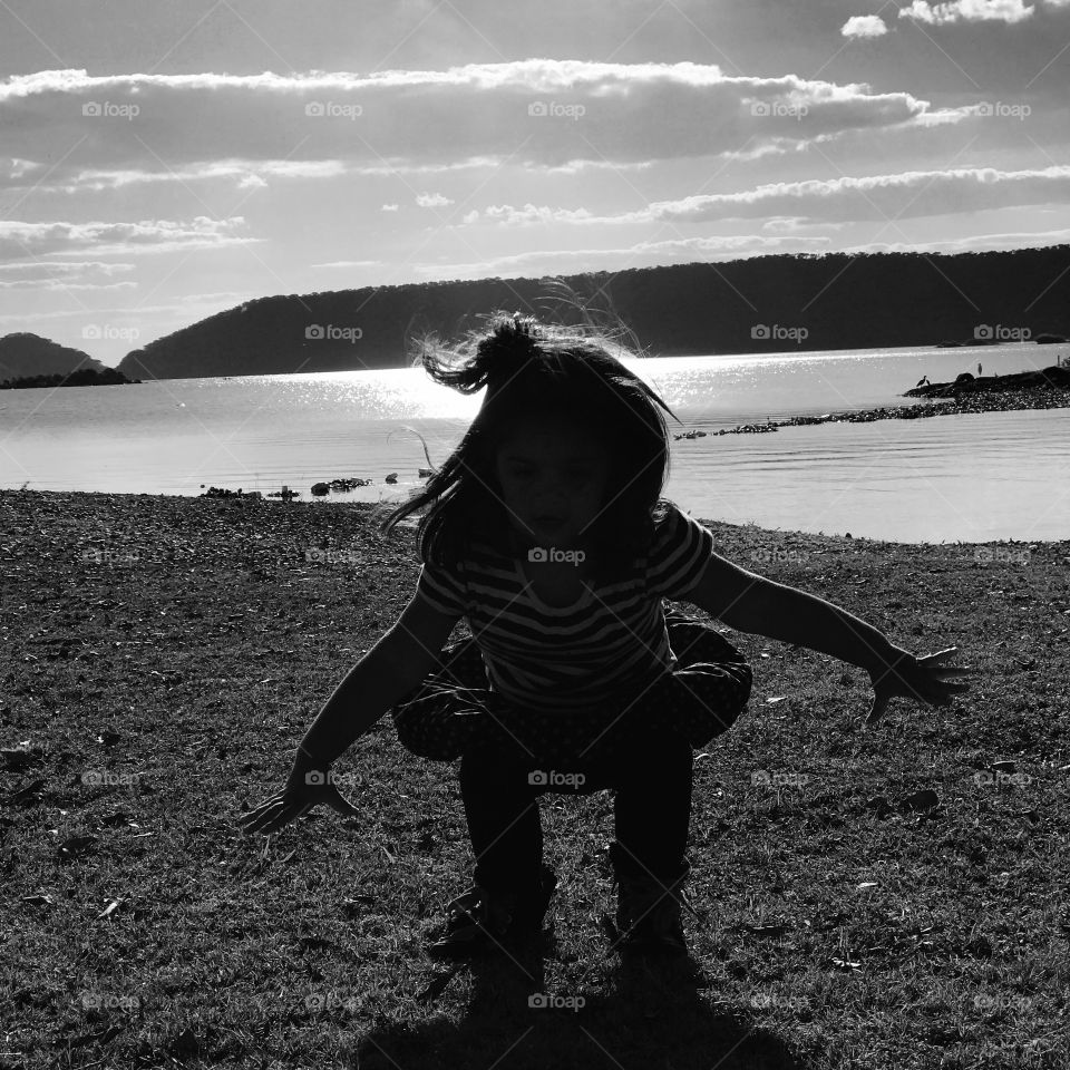 Playing with shadows Black and white Photo kids at the lake