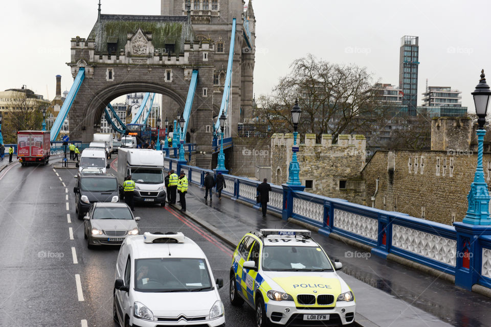 Police stops car in traffic at Tower bridge in London.