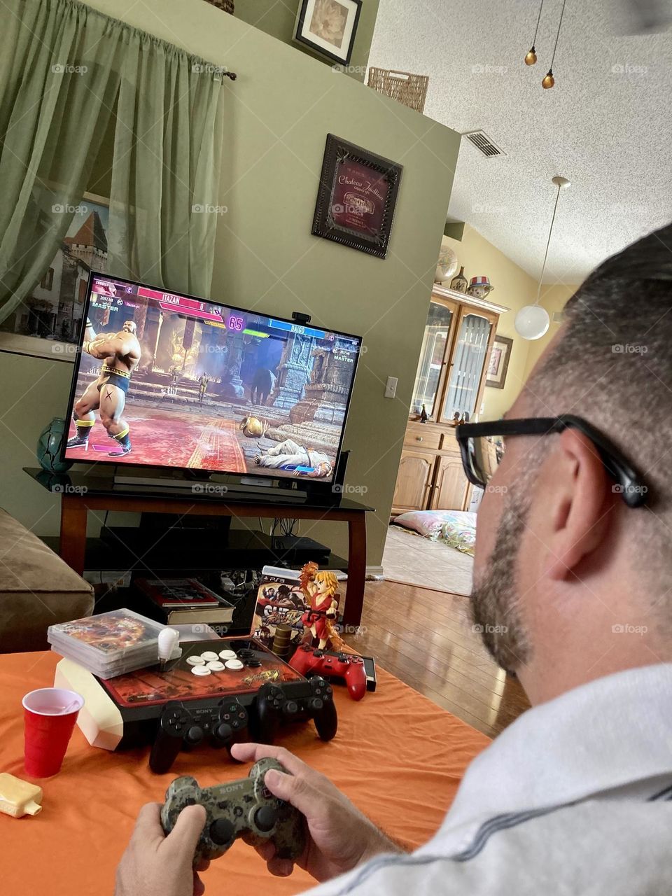 Man playing street fighter video game photography mission 