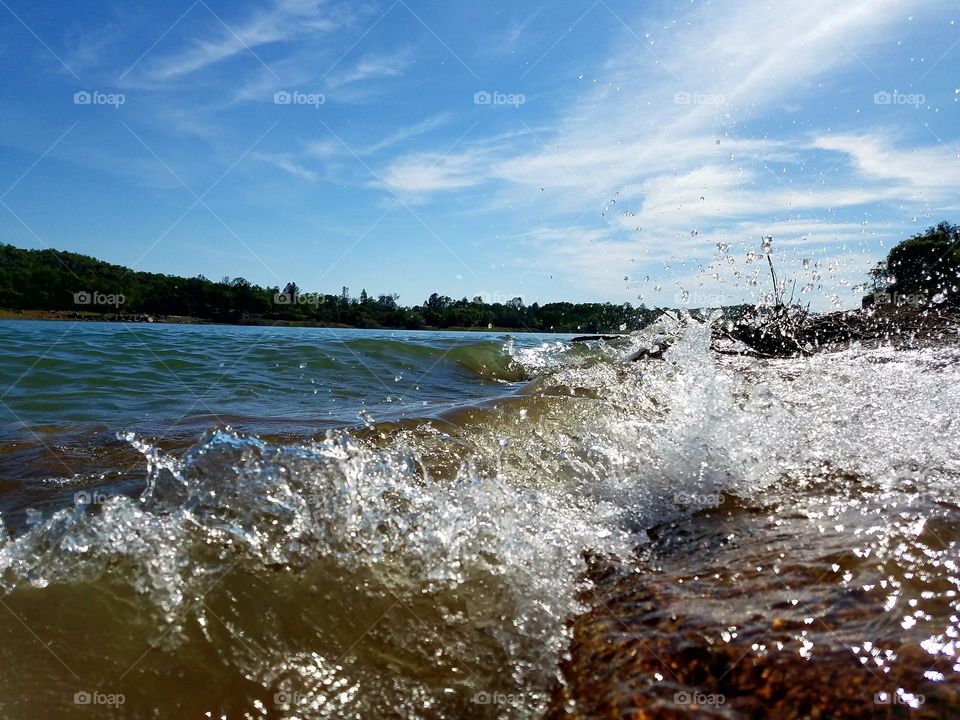 Waves breaking over a log at Folsom lake