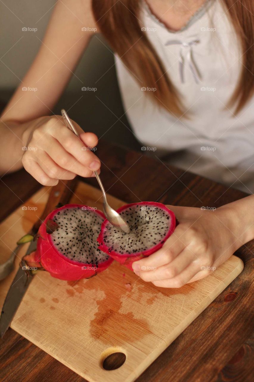 Dragon fruit in the process of eating by a child