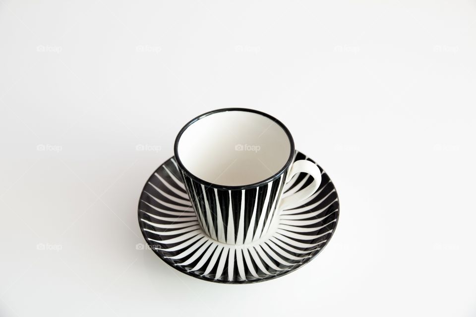 Black and white striped cup with saucer