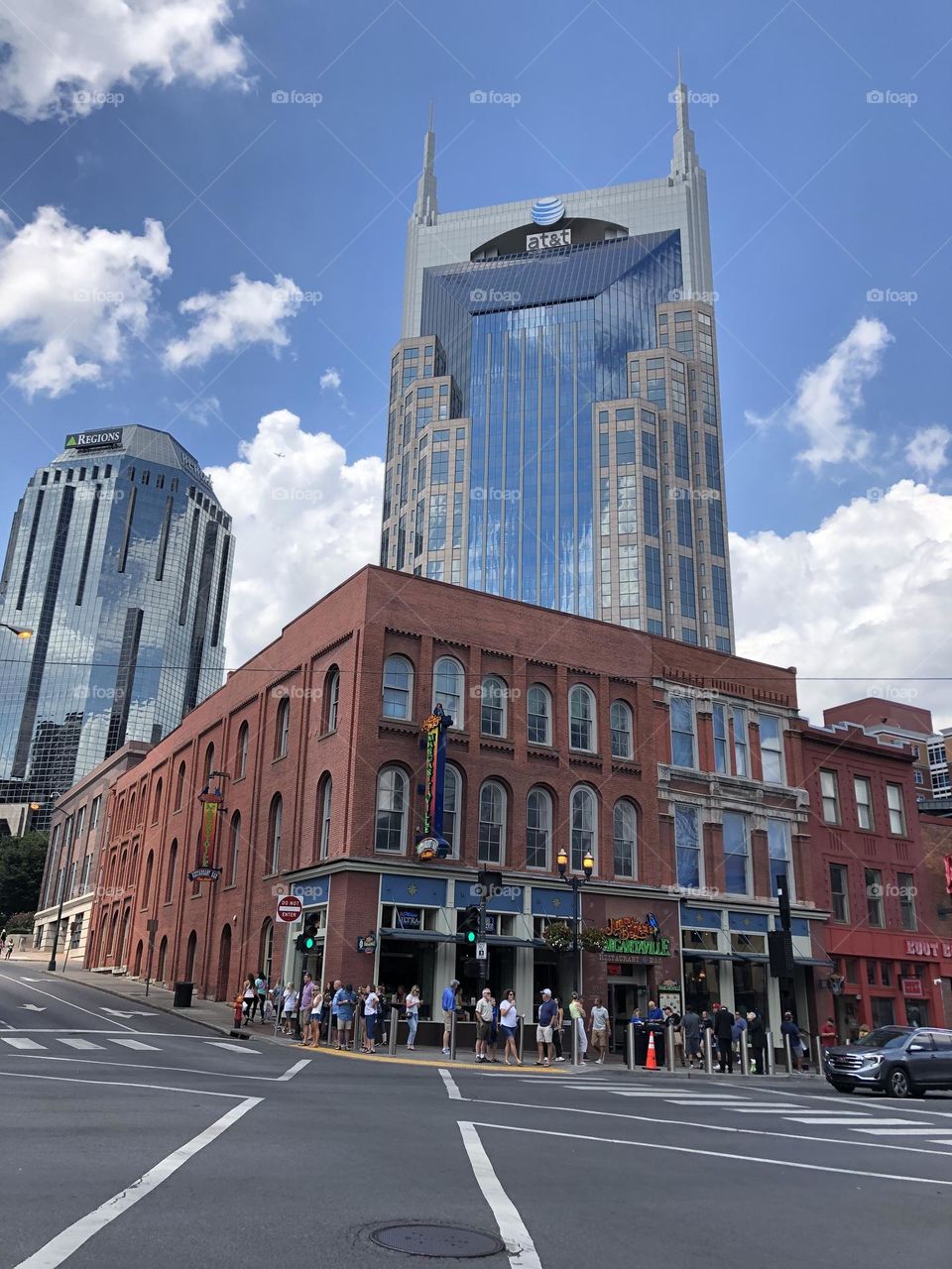 Downtown Nashville Tennessee sunny August summer city day tourist Batman building margaritaville clouds sky street corner mirror reflection AT&T tower