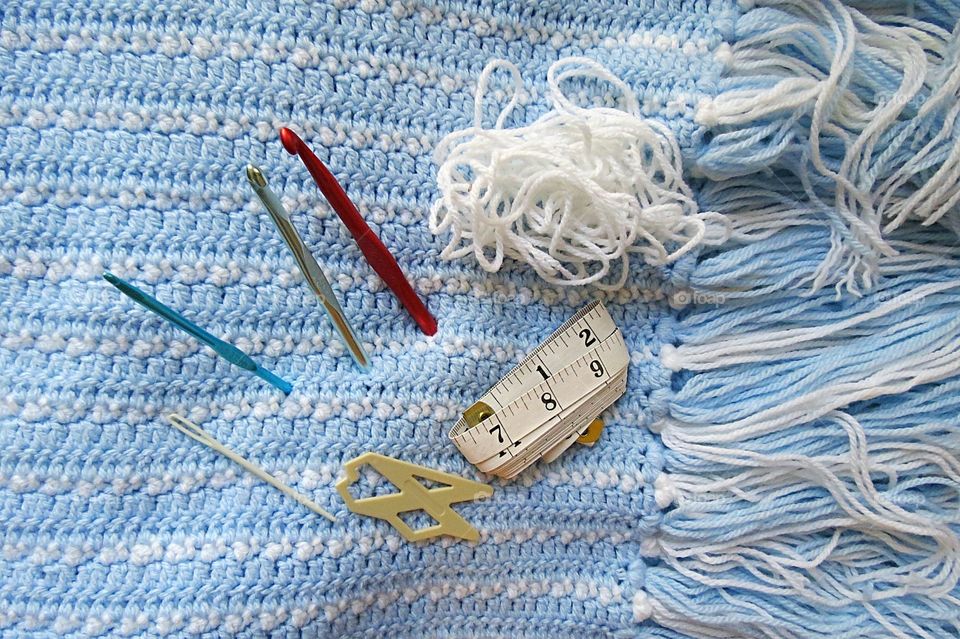 Crocheting a baby blanket.