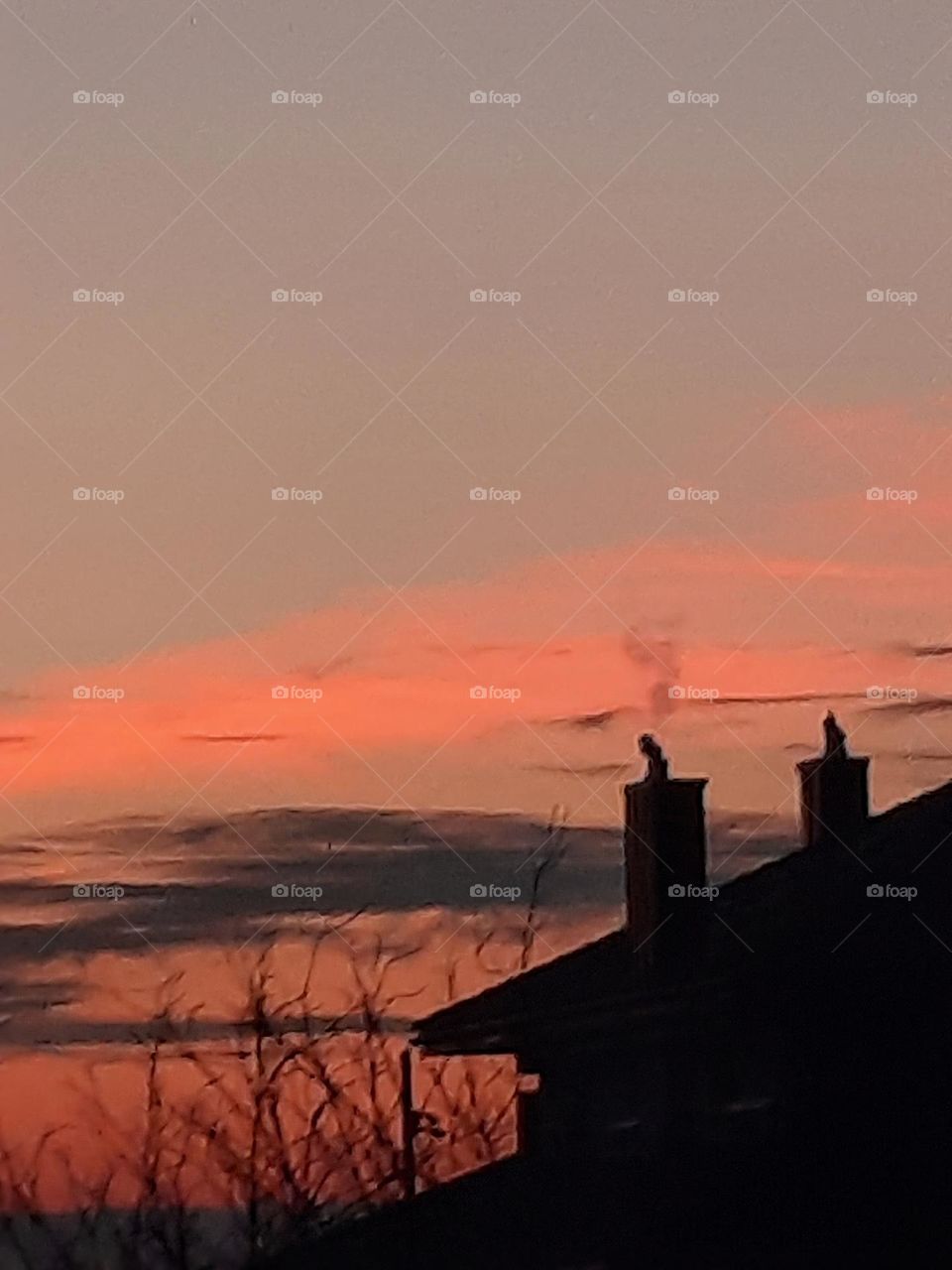 orange sunrise  with black silhouette of house