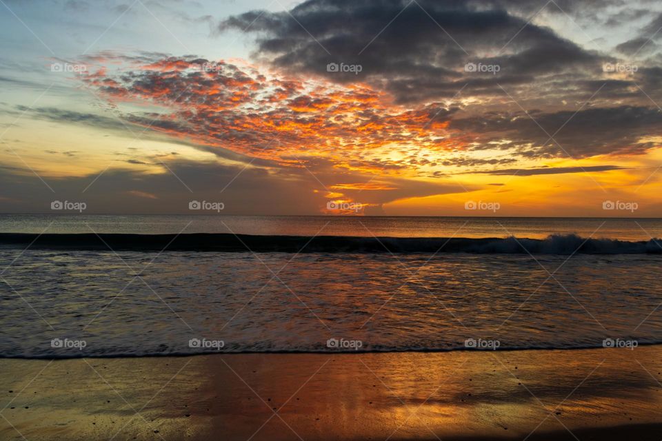 Beautiful sunrise in the eastern coast of the tropical wonder Sri Lanka. Cool breeze, clean waters, golden sandy beaches and perfect colours to start your day.